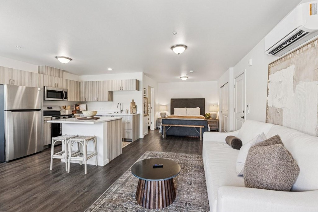 A modern kitchen with a white couch and a coffee table.