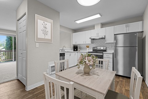 A modern kitchen with a dining table and chairs.