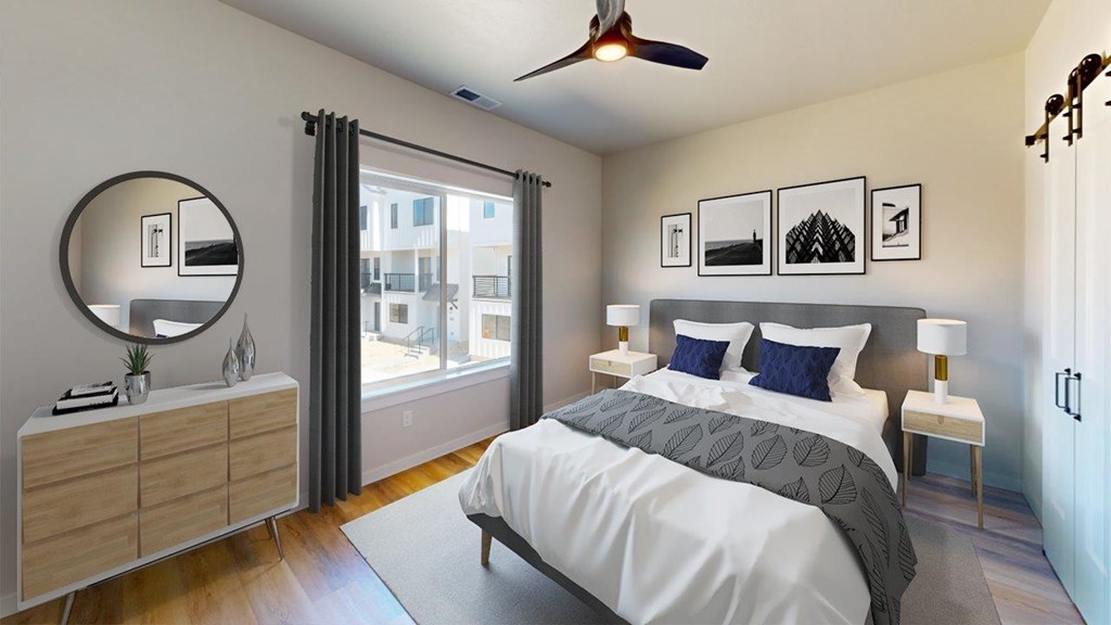 A bedroom with a large bed, a dresser, and a ceiling fan.