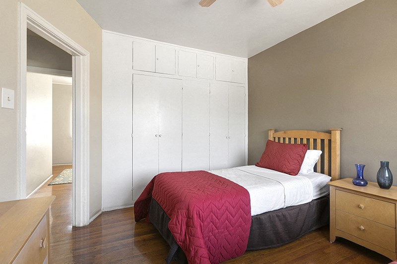 a bedroom with a bed and a dresser