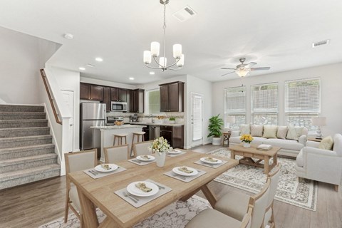 A dining room with a table set for a meal.