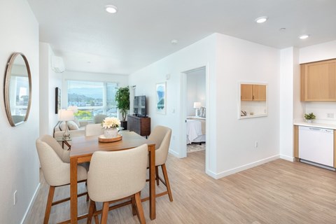 A dining room with a wooden table and chairs.