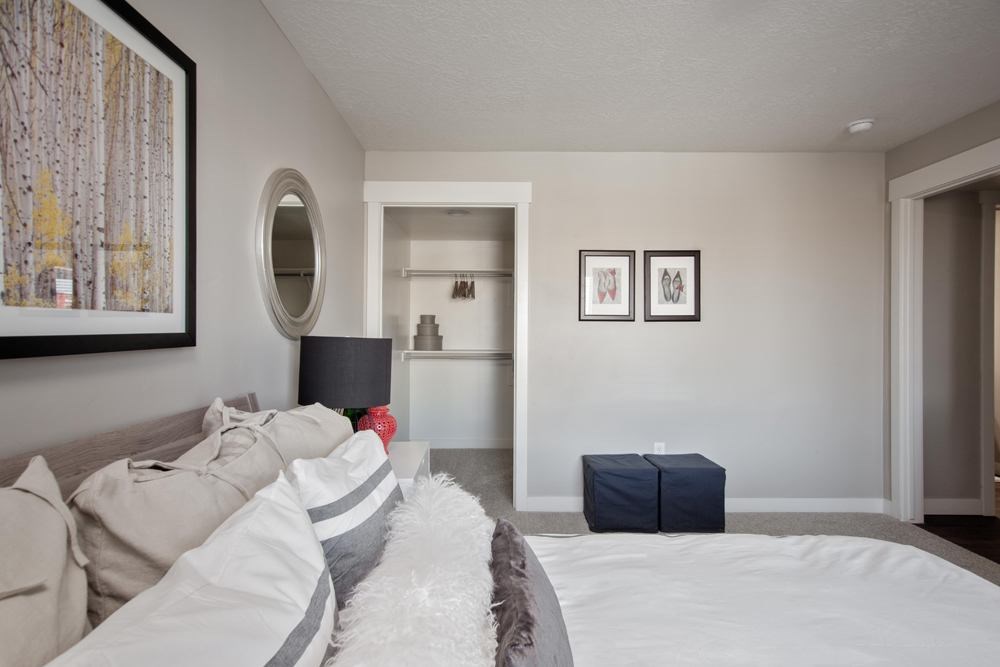 A bedroom with a large bed and a painting on the wall.