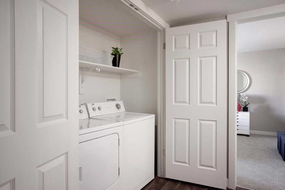 A small white laundry room with a washer and dryer.