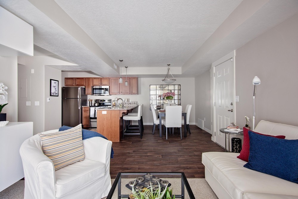 A living room with a white couch and a coffee table.
