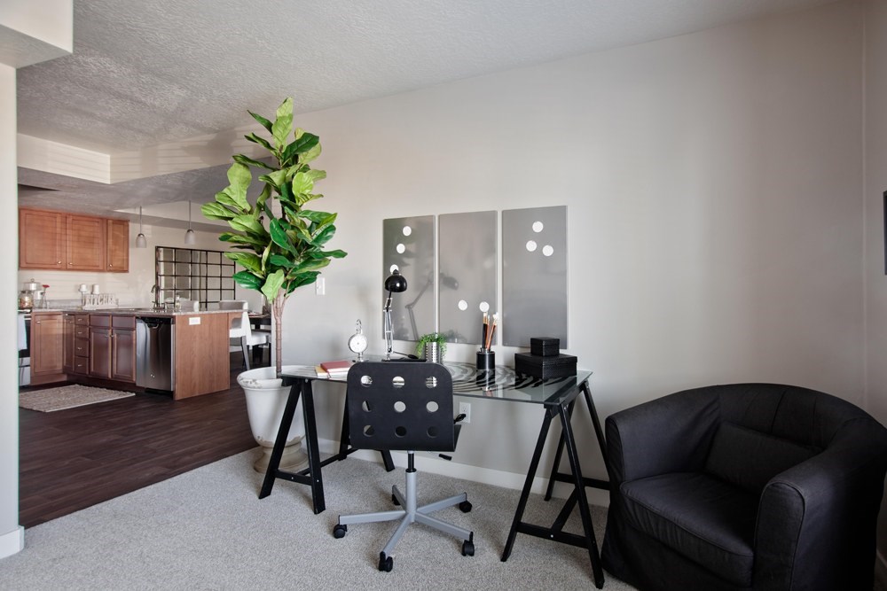 A room with a black chair and a black office chair.