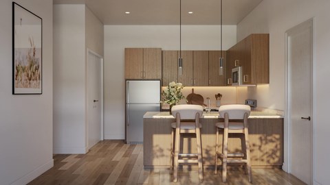 A kitchen with a refrigerator, a sink, and a counter with chairs.