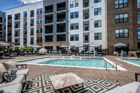 a swimming pool in front of an apartment building