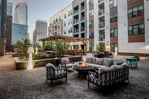 a patio with furniture and a fire pit