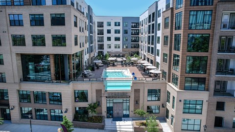 an aerial view of an apartment building with a swimming pool