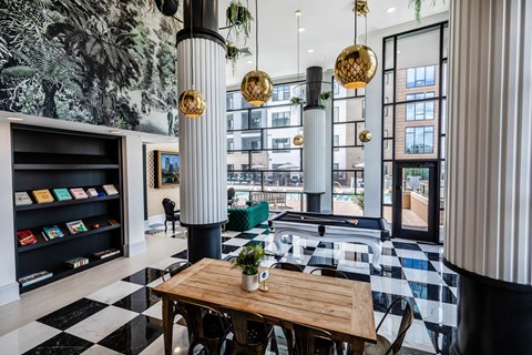 a dining room with black and white checkered floors and a table and chairs