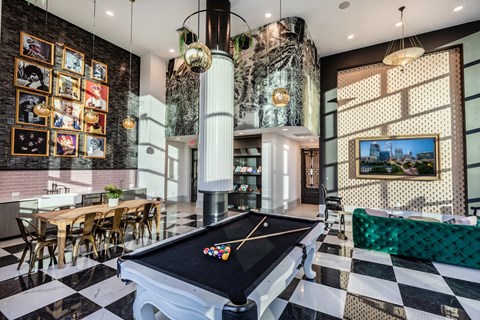 a game room with a pool table and a bar