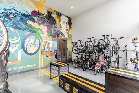 a room with bikes and a mural on the wall
