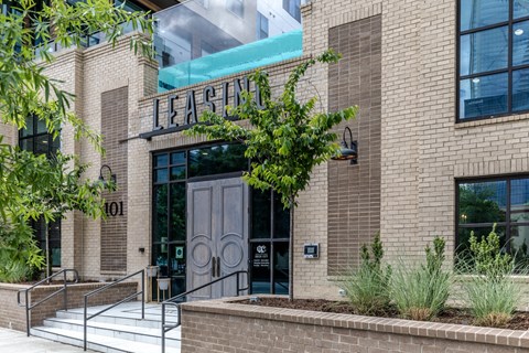 a building with a door and a tree in front of it