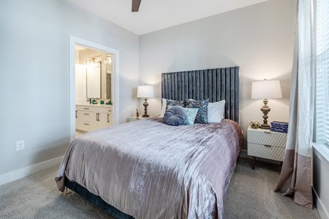 a bedroom with a bed and a closet with a mirror