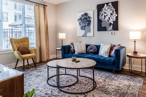 a living room with a blue couch and a round coffee table