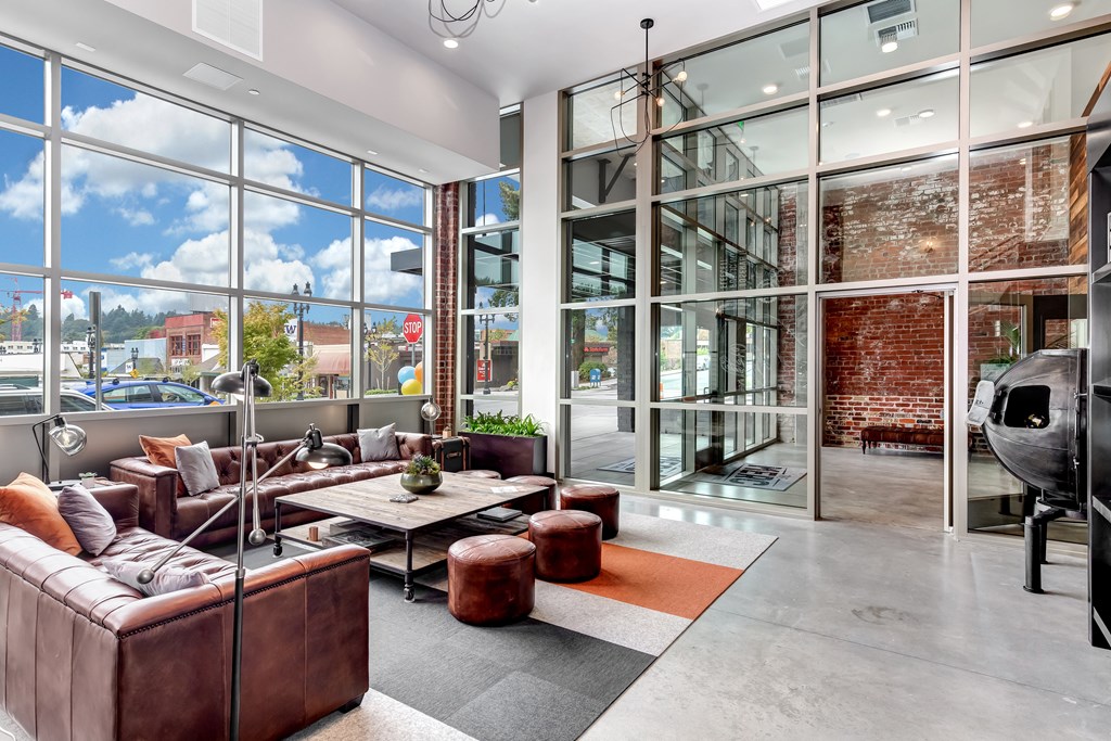 A modern living room with a view of the city through large windows.