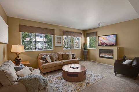 A living room with a couch, coffee table, and a painting on the wall.