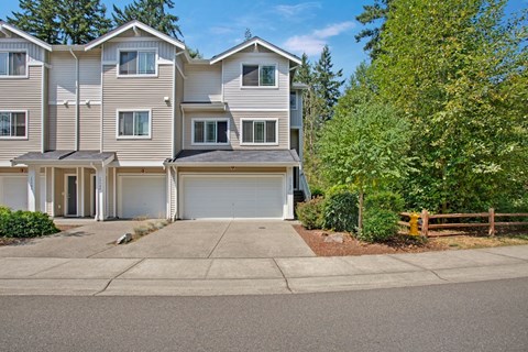 A large, multi-story residential building with a driveway in front.