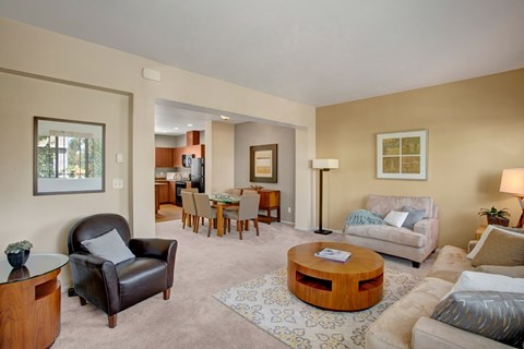 A living room with a brown leather chair and a wooden coffee table.