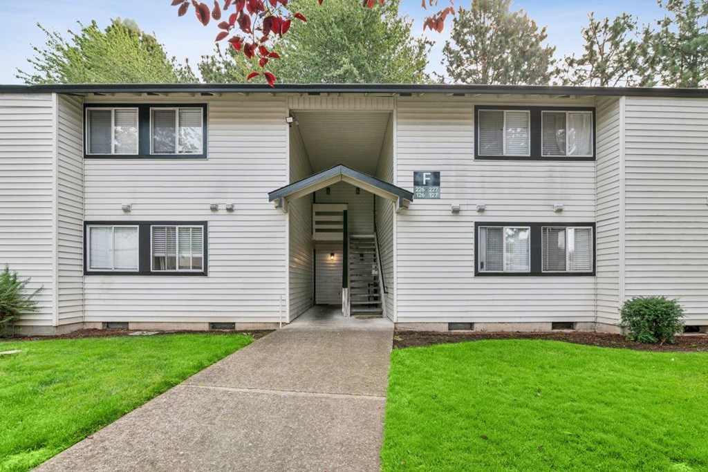 A building with a grey facade and a white door.