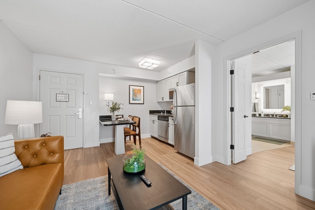 A modern kitchen with a refrigerator, sink, and oven.