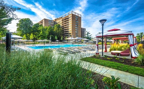 A pool area with a red and white canopy structure.