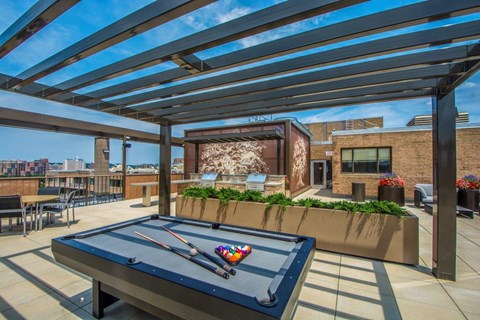 A pool table is set up on a patio.