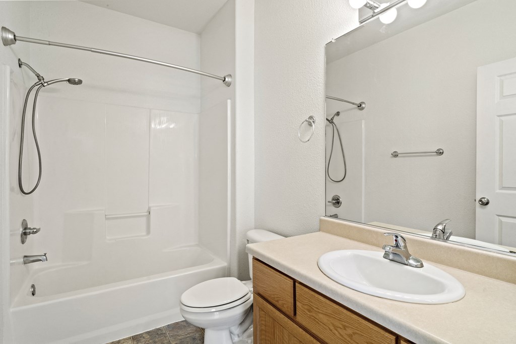 a bathroom with a toilet sink and shower