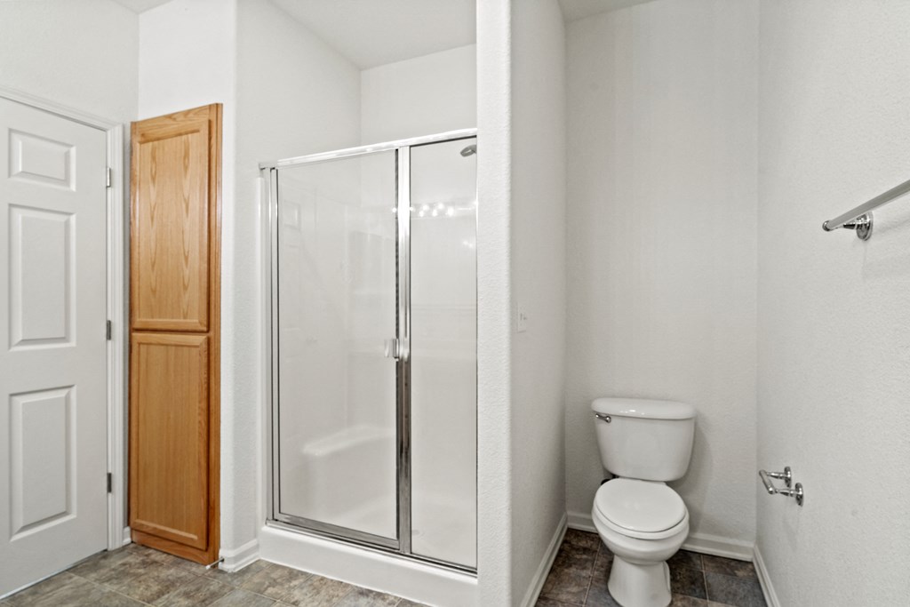 a bathroom with a toilet and a shower
