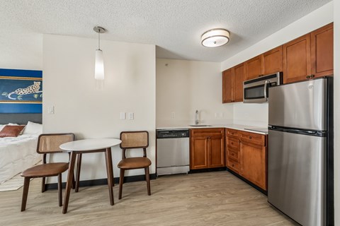 A kitchen with a table and chairs.