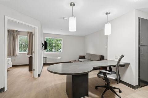 A modern living room with a round table and a television.