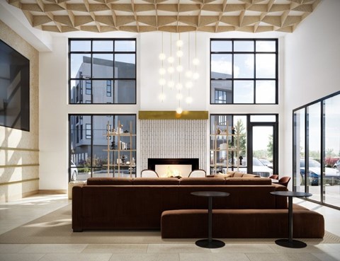 A modern living room with a brown sofa and a large window.