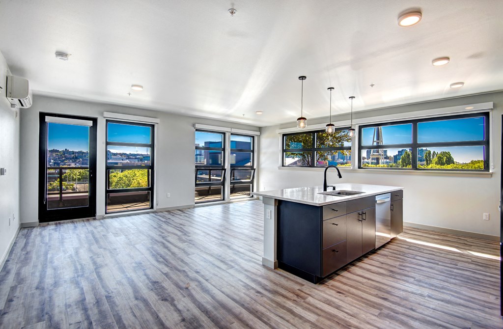 an open living room with a kitchen and a view of the city