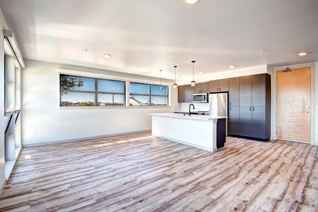 an open kitchen and living room with a large window