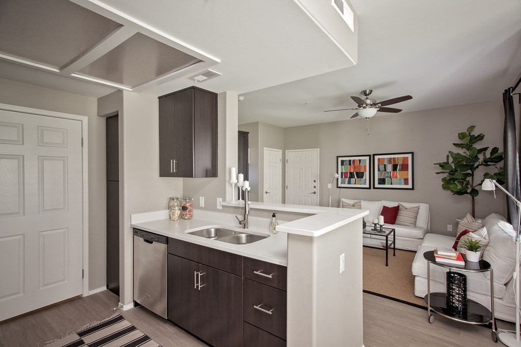 an open kitchen and living room with a ceiling fan