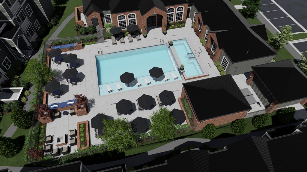 an aerial view of a swimming pool with black umbrellas and a brick building in the