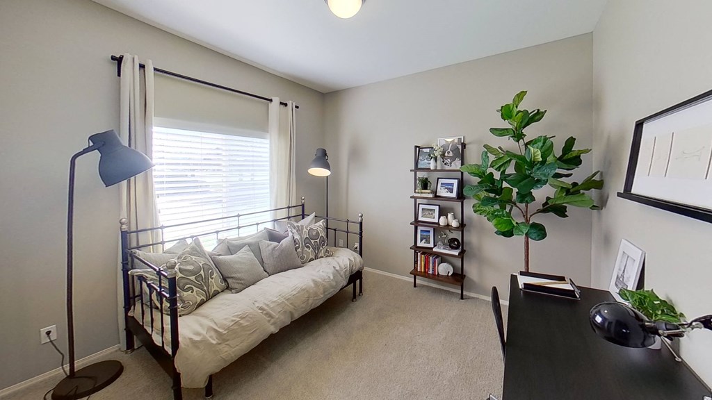 a bedroom with a bed and a desk