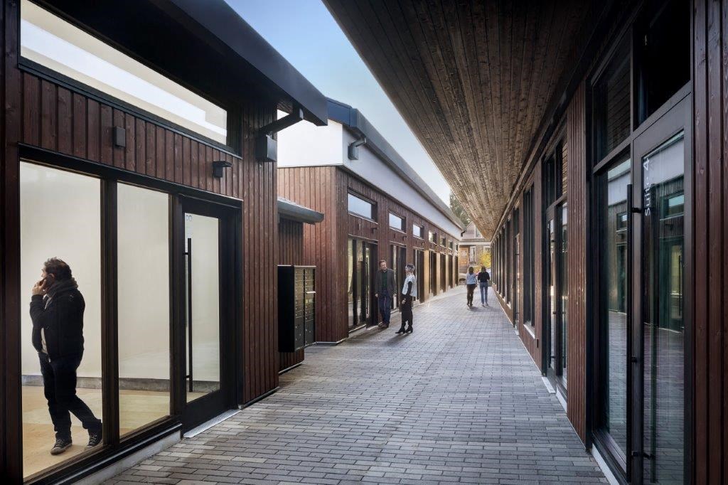 people walking down a sidewalk in a shopping mall