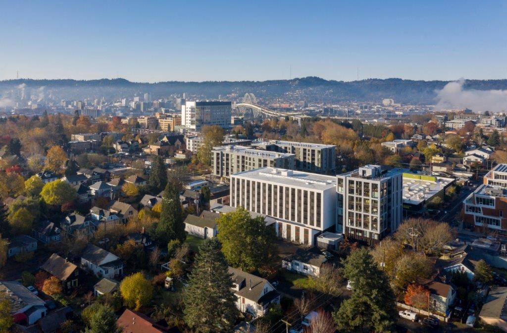 an aerial view of a city with buildings and trees