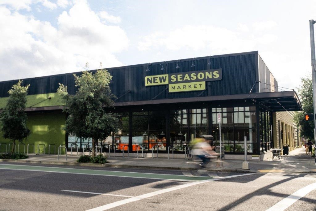 a man riding a bike down a street in front of a building