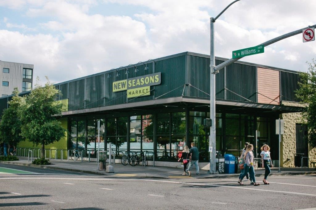 people crossing the street in front of a building
