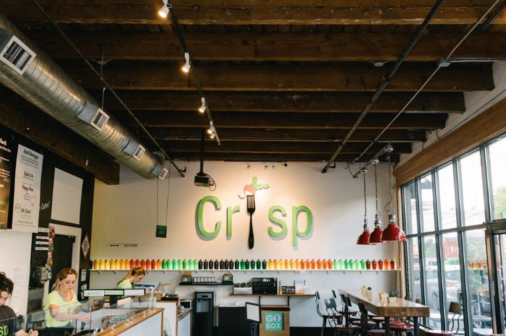 the interior of a restaurant with people sitting at tables