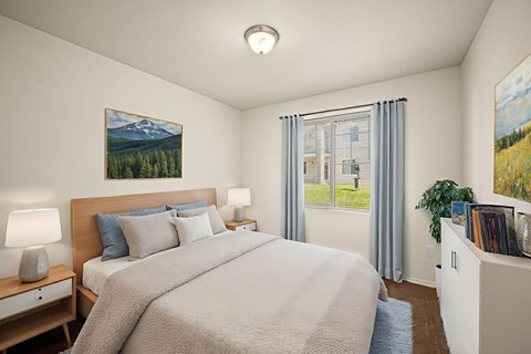 A bedroom with a large bed and a painting of a mountain scene on the wall.