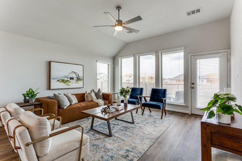 a living room with a couch and a ceiling fan