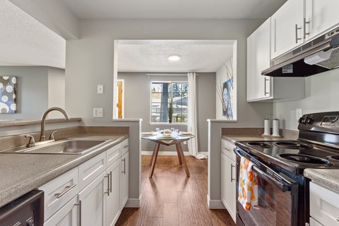 A kitchen with a black stove top oven.