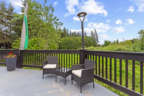 A patio with a table and chairs and a lamp post.