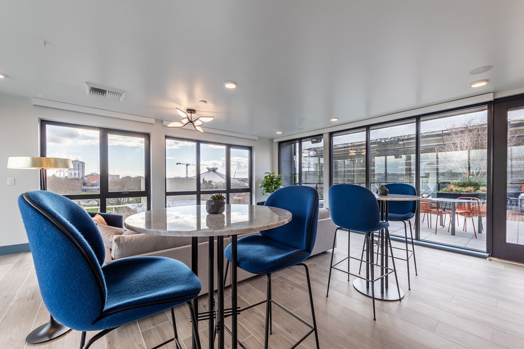 A dining area with blue chairs and a table.