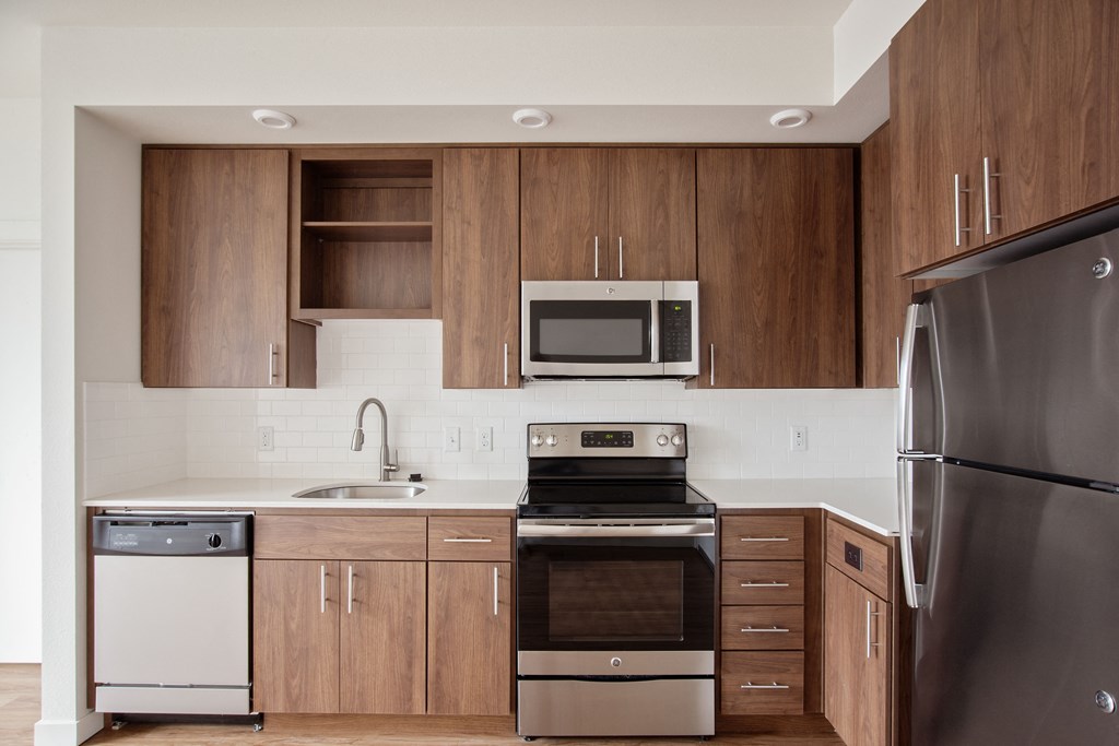 a kitchen with stainless steel appliances and wooden cabinets