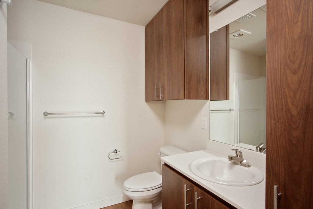 an empty bathroom with a sink toilet and mirror